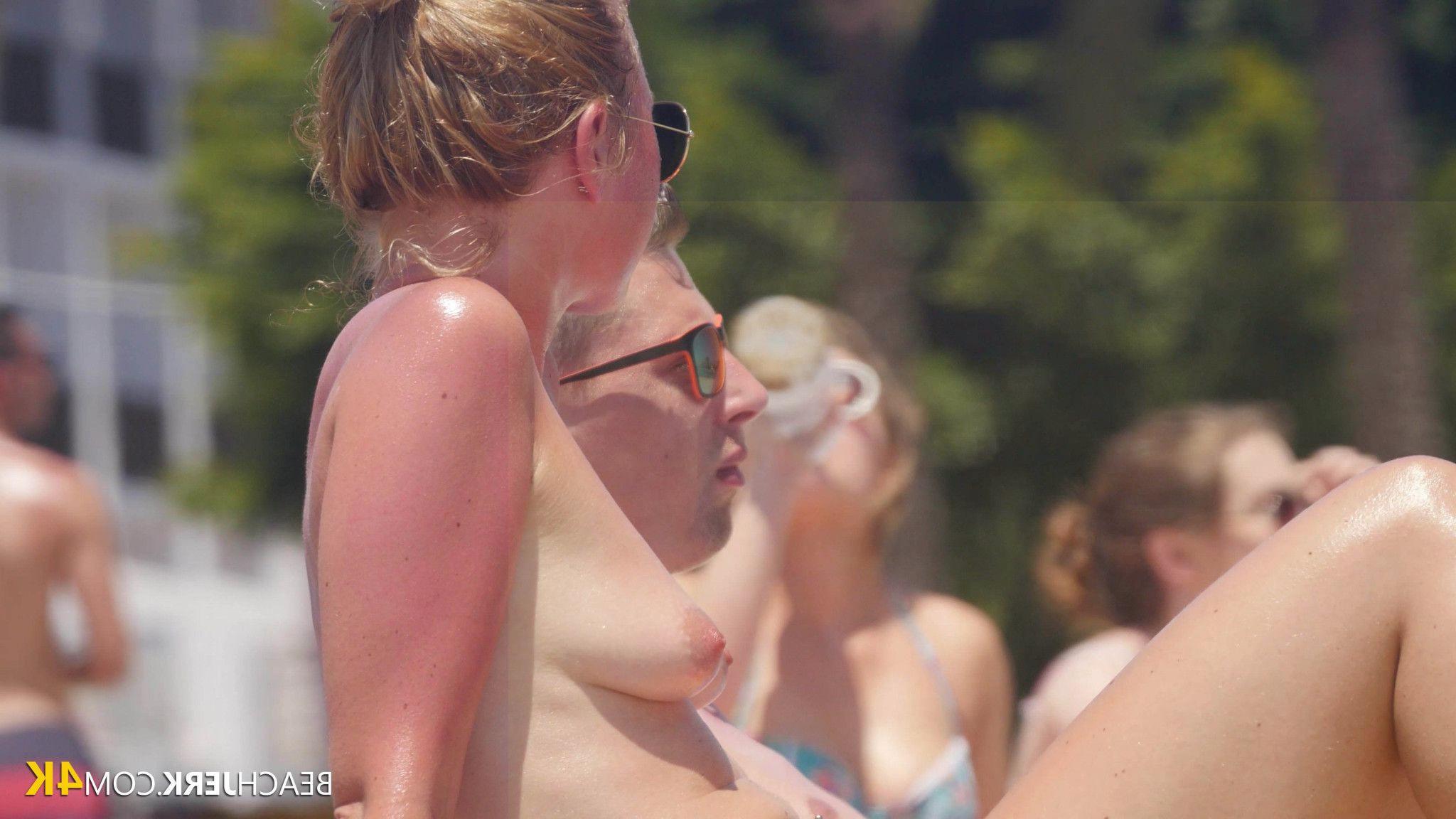 Slender girl applying sunscreen to her breasts Photo